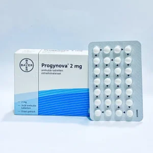 "Progynova 2mg tablet packaging showing white box with Bayer logo and blue wave design, alongside blister pack containing white round tablets"